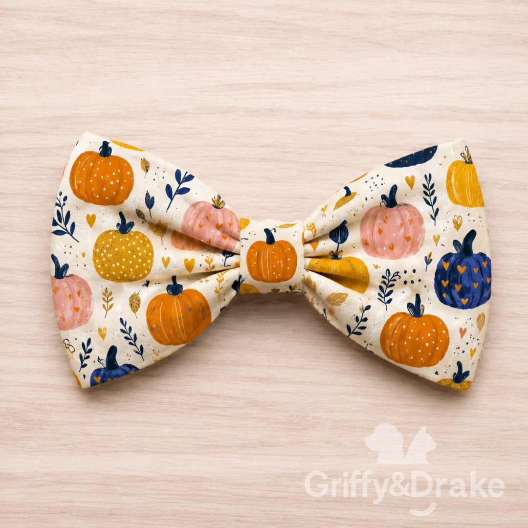 Large cream pet bow tie with orange, mustard, pink, and navy pumpkins.