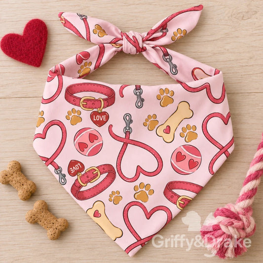 Love Unleashed pet bandana with pink collars, heart-shaped leashes, tennis balls, bones and paw prints.