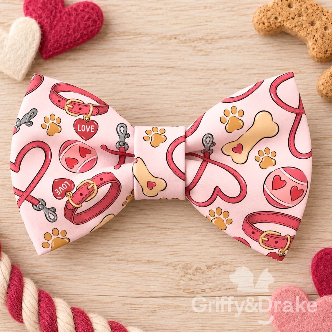 Love Unleashed pet bow tie featuring pink collars, heart leashes, bones, tennis balls and paw prints.